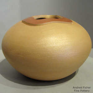 Polished organic opening on a golden micaceous jar