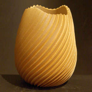 Scalloped opening on a micaceous carved swirl vase