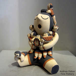 8 children on a grandmother storyteller figure