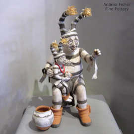 A child, a pot and a tree stump are parts of the History Speaks koshare storyteller figure