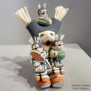 Three children on a koshare storyteller