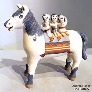 Three children riding on a horse