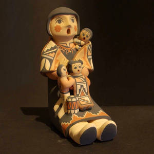 Three children on a grandmother storyteller with a shawl