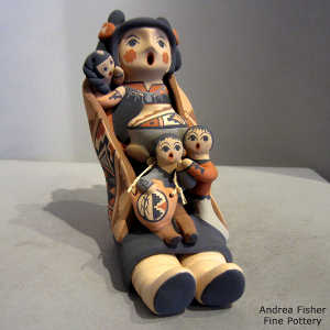 3 children, a pot and a canteen on a grandmother storyteller