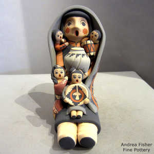 4 children, a pot and a wedding basket on a grandmother storyteller in a manta