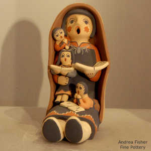 3 children on a grandmother storyteller in a manta