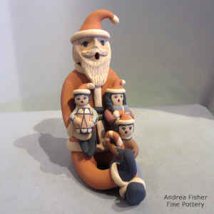 3 children sitting on a Santa Claus storyteller