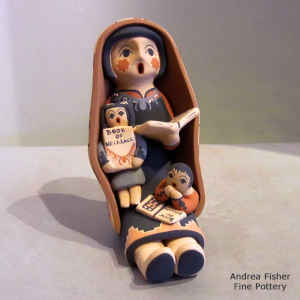 2 children on a grandmother storyteller who is wearing a manta