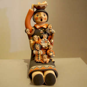 Seven children on a storyteller figure