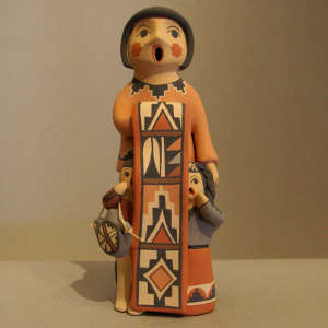 Two children on a standing storyteller figure