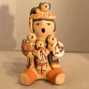 Four children on a polychrome grandfather storyteller