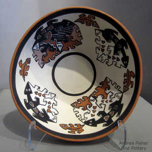 Geometric design outside and Mimbres-style lizard design inside this polychrome bowl