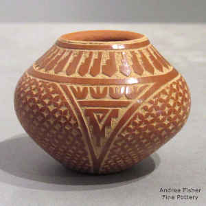 Sgraffito feather, kiva step and geometric design on a miniature red jar