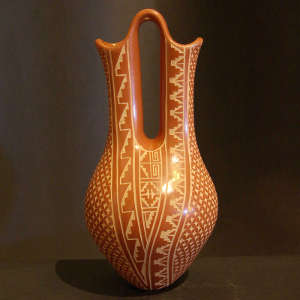 Sgraffito geometric designs on a red wedding vase