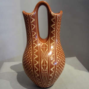 Sgraffito geometric designs on a polished red wedding vase