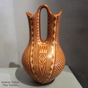 Sgraffito feather, kiva step and geometric design on a red wedding vase