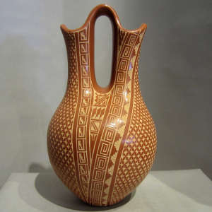 Sgraffito geometric designs on a polished red wedding vase