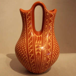 Sgraffito geometric design on a polished red wedding vase