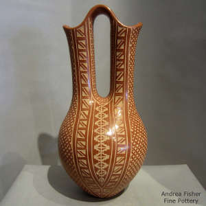 Sgraffito geometric design on a polished red wedding vase