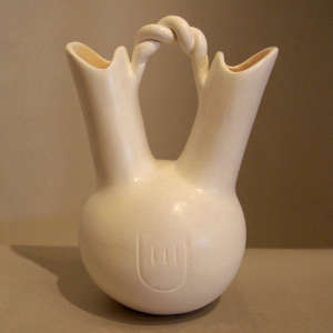 Twisted handle and bear paw imprint on a white wedding vase