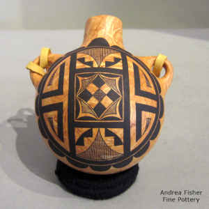 Black geometric design on a mixed-clay canteen