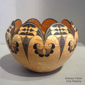 Geometric design on a marbleized clay jar with a scalloped opening