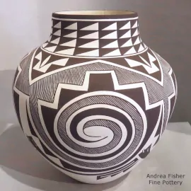 Fine line, spiral and geometric design on a black and white jar