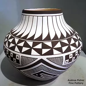 Fine line and geometric design on a black and white jar