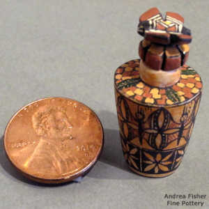 Floral, butterfly and geometric design on a miniature lidded polychrome jar