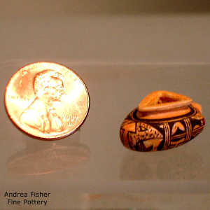 Shard and geometric design on a miniature triangular polychrome jar
