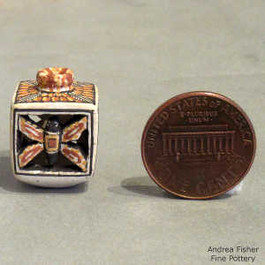 Feather, butterfly and geometric design on a miniature polychrome jar
