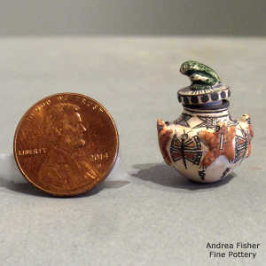 Frog, butterfly and geometric design on a miniature lidded polychrome jar