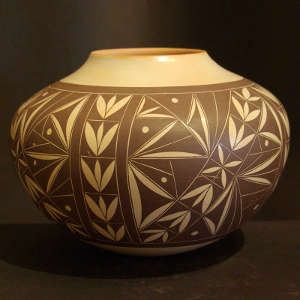 Leaf and floral design on a black and cream jar