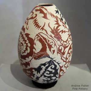 Sgraffito wildlife and geometric design on a polychrome jar