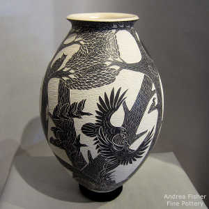 Sgraffito nature and wildlife design on a black and buff jar