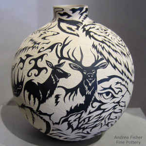 Black and white jar with sgraffito wildlife and geometric design