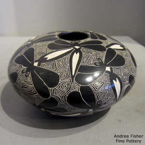 Sgraffito dragonfly and geometric design on a black and white jar