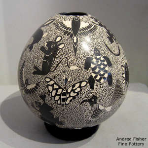 Sagraffito animal, insect and mesh design on a black and white jar