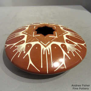 Geometric opening on a red and white jar with geometric design