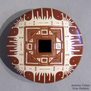 Geometric opening and painted geometric design on a white on red jar