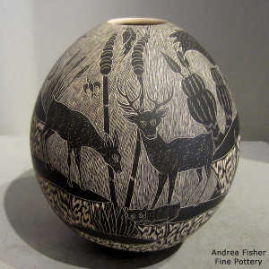 Sgraffito wildlife and nature design on a black and white jar