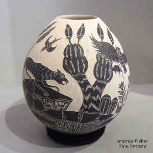 Sgraffito desert wildlife and nature scene on a black and white jar