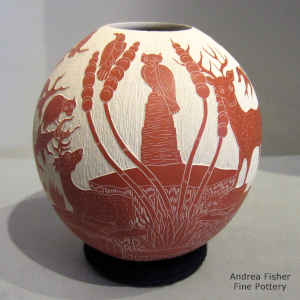 Sgraffito nature design on a red and white jar