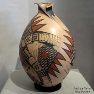 An organic opening on a polychrome jar with a bird element and geometric design