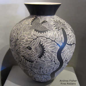 Sgraffito bird, branch and flower design on a black and white jar
