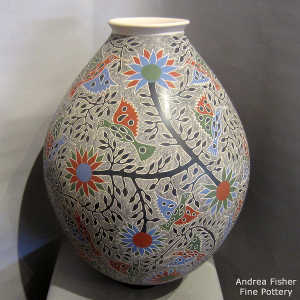 Sgraffito and painted bird, branch and flower design on a polychrome jar