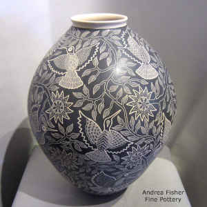 Sgraffito bird, branch and flower design on a large black and white jar