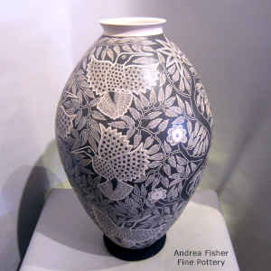 Sgraffito bird, branch and flower design on a large black and white jar