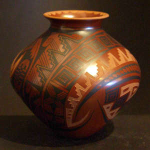 Sgraffito and painted geometric designs on a red jar