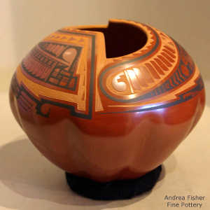 Melon bottom and Paquime designs on the upper shoulder of a red jar